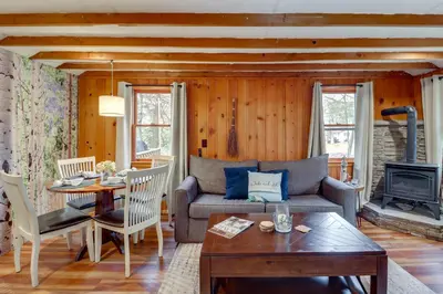 a living room with a couch and a table at Cozy Lake Wallenpaupack Cabin with Community Perks in Lake Ariel