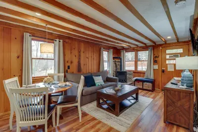 a living room with a couch and a table at Cozy Lake Wallenpaupack Cabin with Community Perks in Lake Ariel