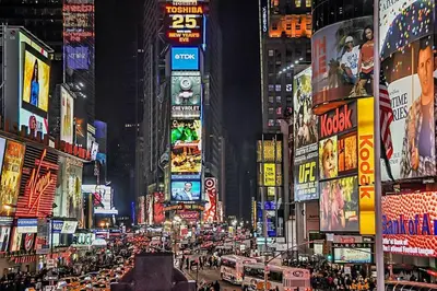 a busy city street at night with many signs at Free Parking in Prime Area w King bd in Newark