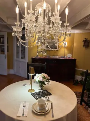 a dining room with a table with a chandelier at Antique1242 British Bed & Breakfast in Enfield
