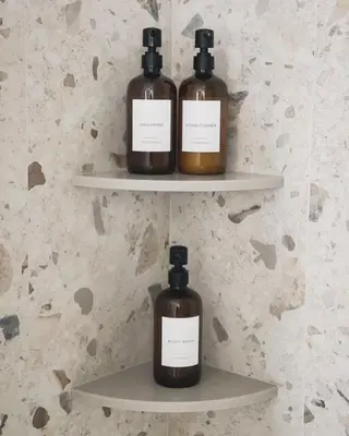 three bottles of soap sitting on shelves on a wall at Berkshire Valley Inn in Williamstown