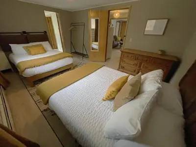 a bedroom with two beds and a mirror at Berkshire Valley Inn in Williamstown