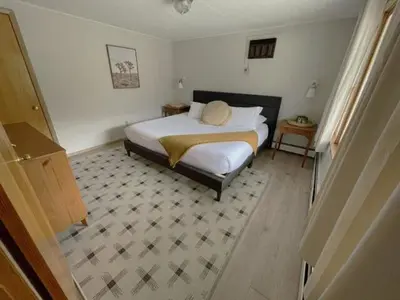 a bedroom with a bed and a tiled floor at Berkshire Valley Inn in Williamstown