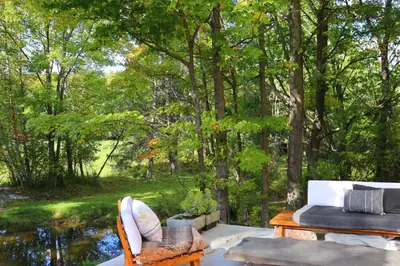 a living room with a view of a forest at WOODSTOCK HISTORIC ARTIST ESTATE - THE MUSEUM HOUSE in Woodstock