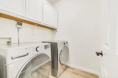 a white laundry room with a washer and dryer at Beach and Lake Access Family Poconos Home with Deck in Tobyhanna