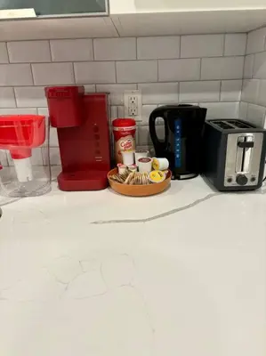 a kitchen counter with a coffee maker and a plate of food at Veau3 1BD 1BA minutes to NYC in Newark