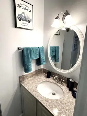 a bathroom with a sink and a mirror at Deluxe Mountain Fox Suite Jiminy Peak - Ski On Off - Fully Redone Decor in Hancock