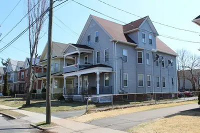a large gray house on the corner of a street at South End Serenity 2 in Hartford
