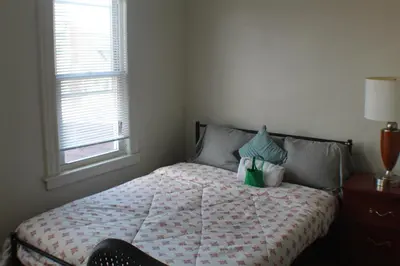 a bedroom with a bed with a lamp on it at South End Serenity 2 in Hartford