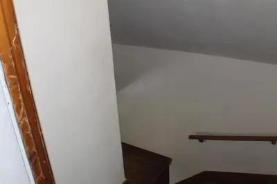 a room with a white wall and a wooden shelf at South End Serenity 2 in Hartford