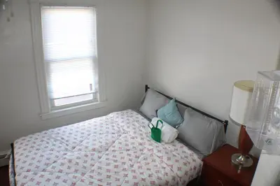 a bedroom with a bed and a window at South End Serenity 2 in Hartford