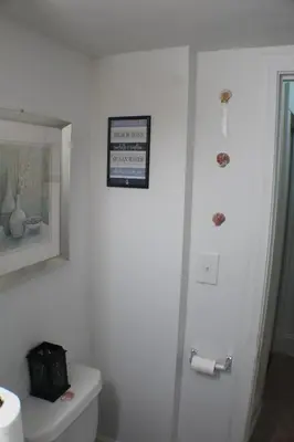 a bathroom with a toilet and a picture on the wall at South End Serenity 2 in Hartford