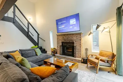 a living room with a couch and a fireplace at Modern chalet for 8 people with Fireplace, Hot Tub and nearby Skiing in Tobyhanna