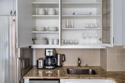 a kitchen with white cabinets and a sink at Kips Bay 1br w doorman wd gym nr hospital NYC-1402 in New York