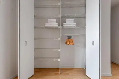 a walk in closet with white walls and white shelves at Kips Bay 1br w doorman wd gym nr hospital NYC-1402 in New York