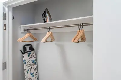 a closet with wooden hangers and a tie at Lenox Hill 2br w elevator doorman nr art NYC-1389 in New York