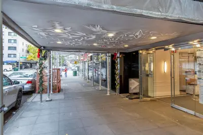 an empty street with a building with a canopy at Lenox Hill 2br w elevator doorman nr art NYC-1389 in New York