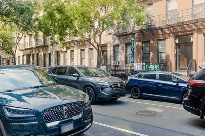 a group of cars parked on a city street at Lenox Hill 2br w elevator doorman nr art NYC-1389 in New York