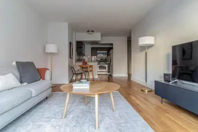 a living room with a couch and a table at Lenox Hill 2br w elevator doorman nr art NYC-1389 in New York