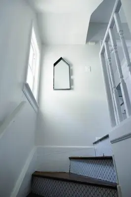 a set of stairs in a building with a window at Rainforest Retreat 20m to NYC FREE Parking - Sleeps 16 in Bayonne