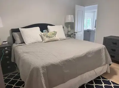 a bedroom with a large bed with pillows on it at Peaceful place at the lake in Susquehanna