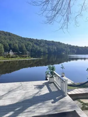 a dock on a lake with a boat on it at Peaceful place at the lake in Susquehanna