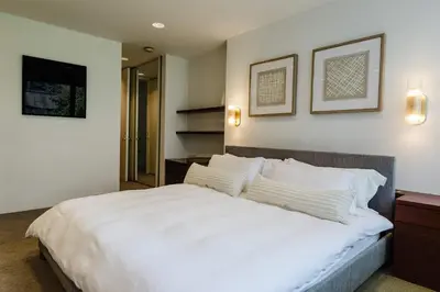a bedroom with a large white bed with white pillows at Private Beautiful Townhome w Zen Garden in New York