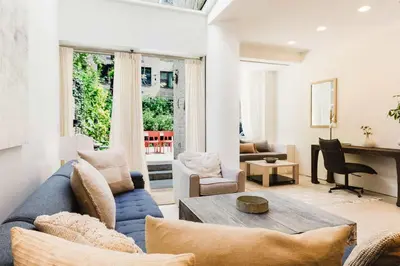a living room with a blue couch and a table at Private Beautiful Townhome w Zen Garden in New York