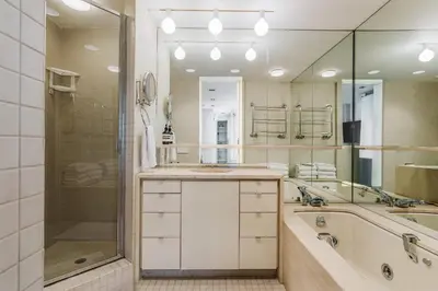 a bathroom with a tub and a sink and a shower at Private Beautiful Townhome w Zen Garden in New York