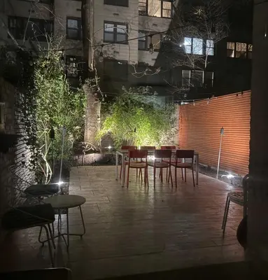 a patio with a table and chairs in a building at Private Beautiful Townhome w Zen Garden in New York