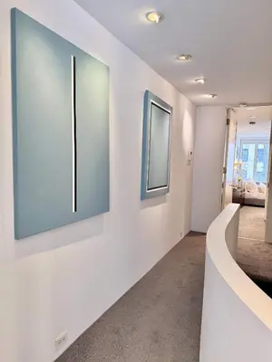 a hallway with white walls and two pictures on the wall at Private Beautiful Townhome w Zen Garden in New York