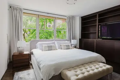 a bedroom with a large bed and a large window at Private Penthouse w Roof Oasis in New York