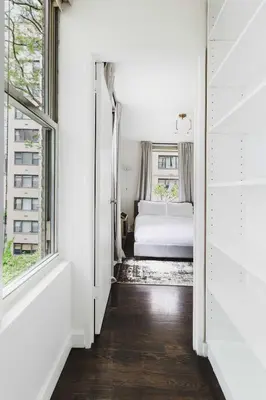 a white bedroom with a bed and a window at Private Penthouse w Roof Oasis in New York