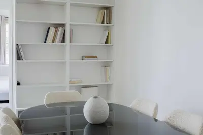 a dining room with a glass table and chairs at Private Penthouse w Roof Oasis in New York