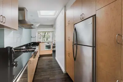 a kitchen with a stainless steel refrigerator at Private Penthouse w Roof Oasis in New York