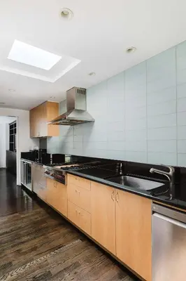 a large kitchen with a sink and a stove at Private Penthouse w Roof Oasis in New York