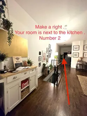 a room with a room with a kitchen with a table and a red arrow at Private room with private bathroom and backyard in Brooklyn