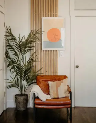 a living room with a chair and a plant at Private room with private bathroom and backyard in Brooklyn
