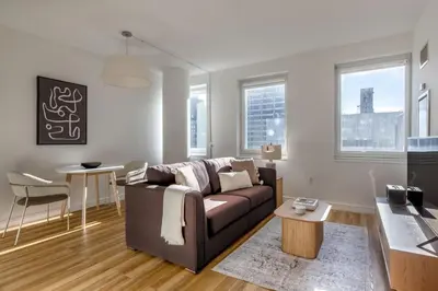 a living room with a couch and a table at Midtown West 1br w doorman nr rockefeller center NYC-1394 in New York