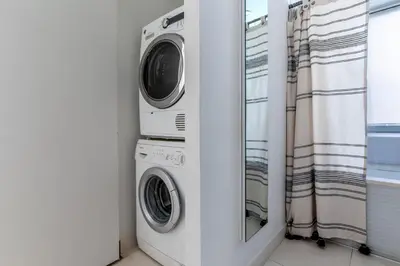 a washer and dryer in a room with a window at Midtown West 1br w doorman nr rockefeller center NYC-1394 in New York