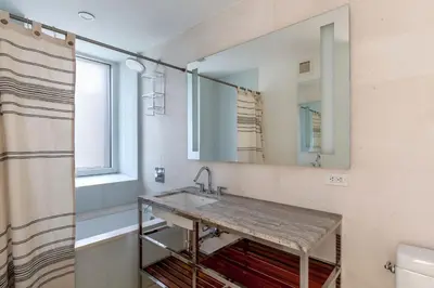 a bathroom with a sink and a mirror at Midtown West 1br w doorman nr rockefeller center NYC-1394 in New York