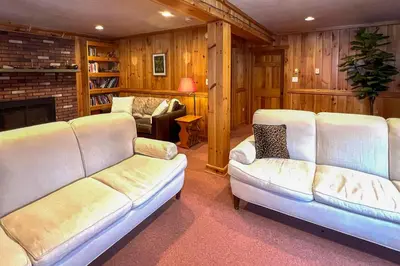 a living room with two white couches and a fireplace at Vacation Rental Home about 2 Mi to Windham Mountain! in Windham