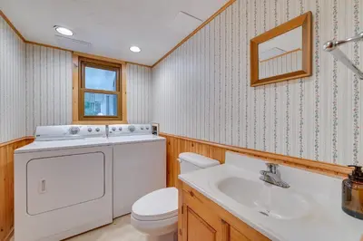 a bathroom with a washing machine and a sink at Vacation Rental Home about 2 Mi to Windham Mountain! in Windham
