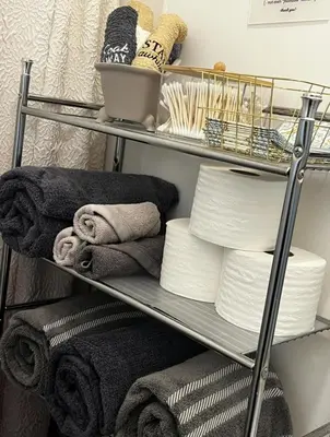 a metal shelf with towels and towels at K-Marie Estate in Mount Vernon