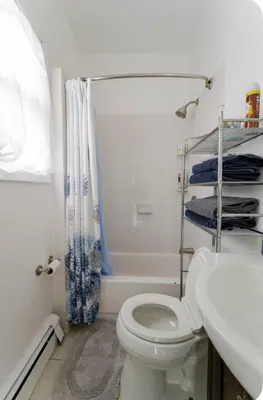 a bathroom with a toilet and a sink and a shower at K-Marie Estate in Mount Vernon