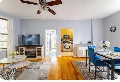 a living room with a table and blue chairs at K-Marie Estate in Mount Vernon