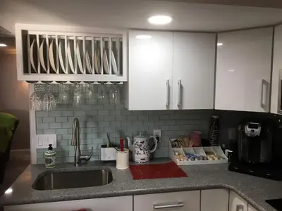 a kitchen counter with a sink and white cabinets at Privacy, entertainment, comfort galore 2 BR LR 1BA Home Theater, Pool Table in Suffield