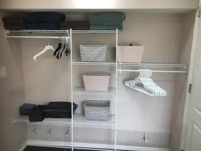 a walk in closet with white shelving at Privacy, entertainment, comfort galore 2 BR LR 1BA Home Theater, Pool Table in Suffield