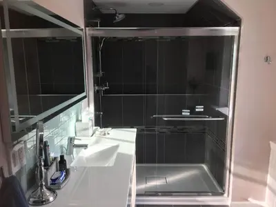 a bathroom with a shower with a sink and a tub at Privacy, entertainment, comfort galore 2 BR LR 1BA Home Theater, Pool Table in Suffield