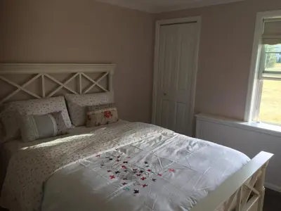 a bedroom with a bed with flowers on it at Privacy, entertainment, comfort galore 2 BR LR 1BA Home Theater, Pool Table in Suffield